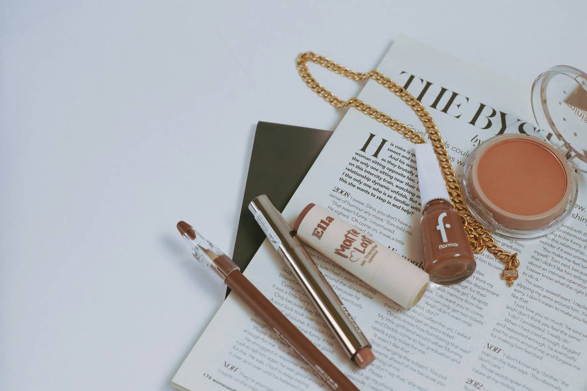 clean girl makeup list featuring minimalist non-toxic foundation, mascara, and lip tint arranged on a marble surface